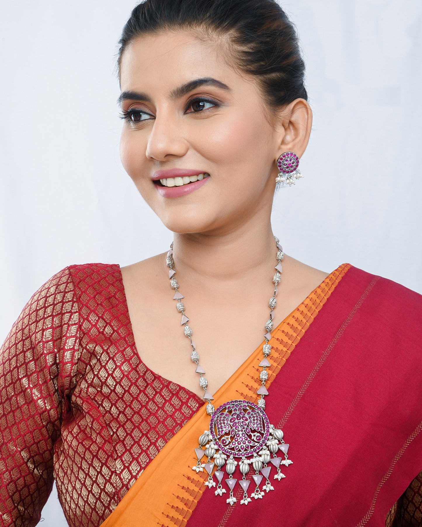 Oxidised silver peacock motif necklace set with magenta accents - Yuvaminie