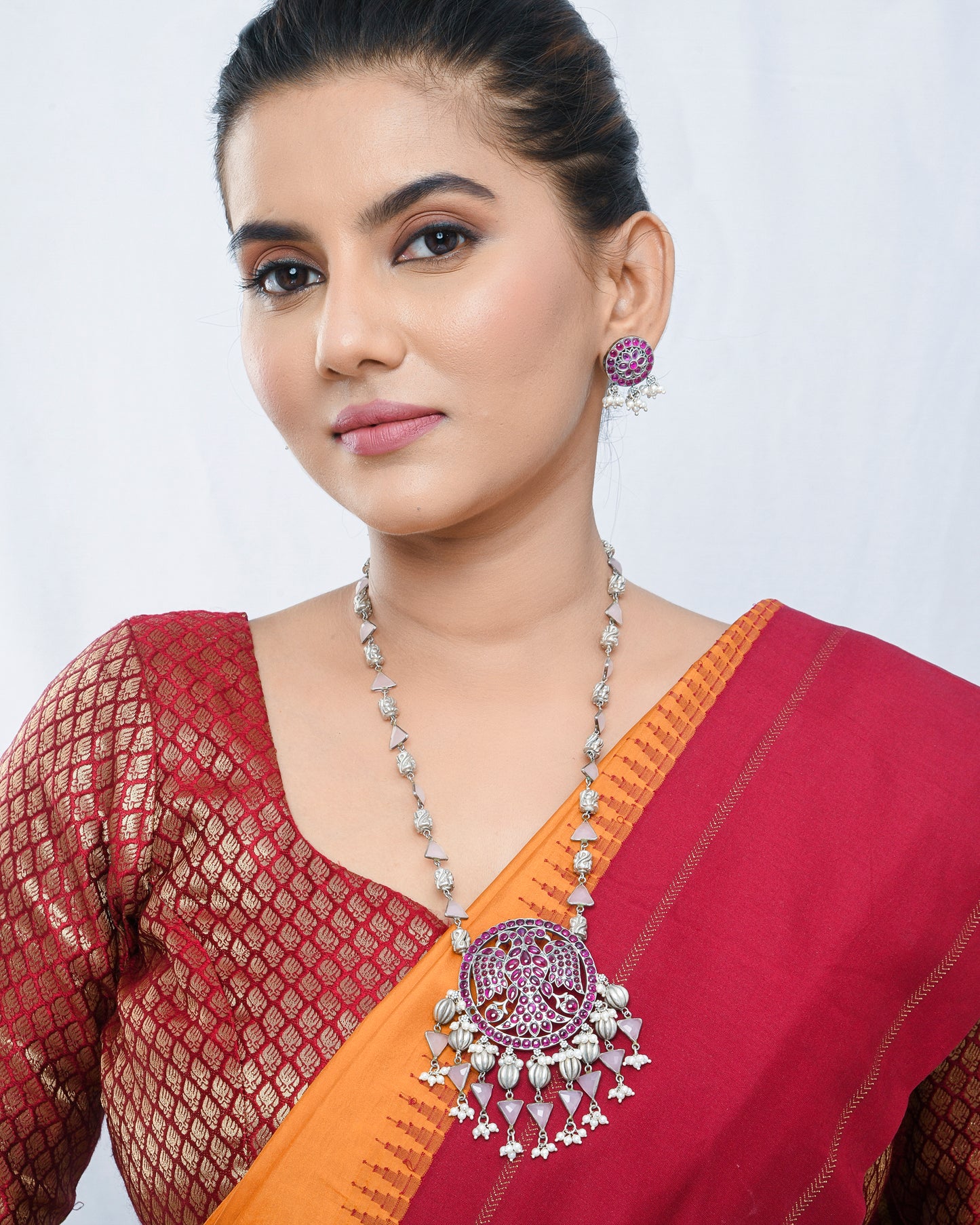 Oxidised silver peacock motif necklace set with magenta accents - Yuvaminie