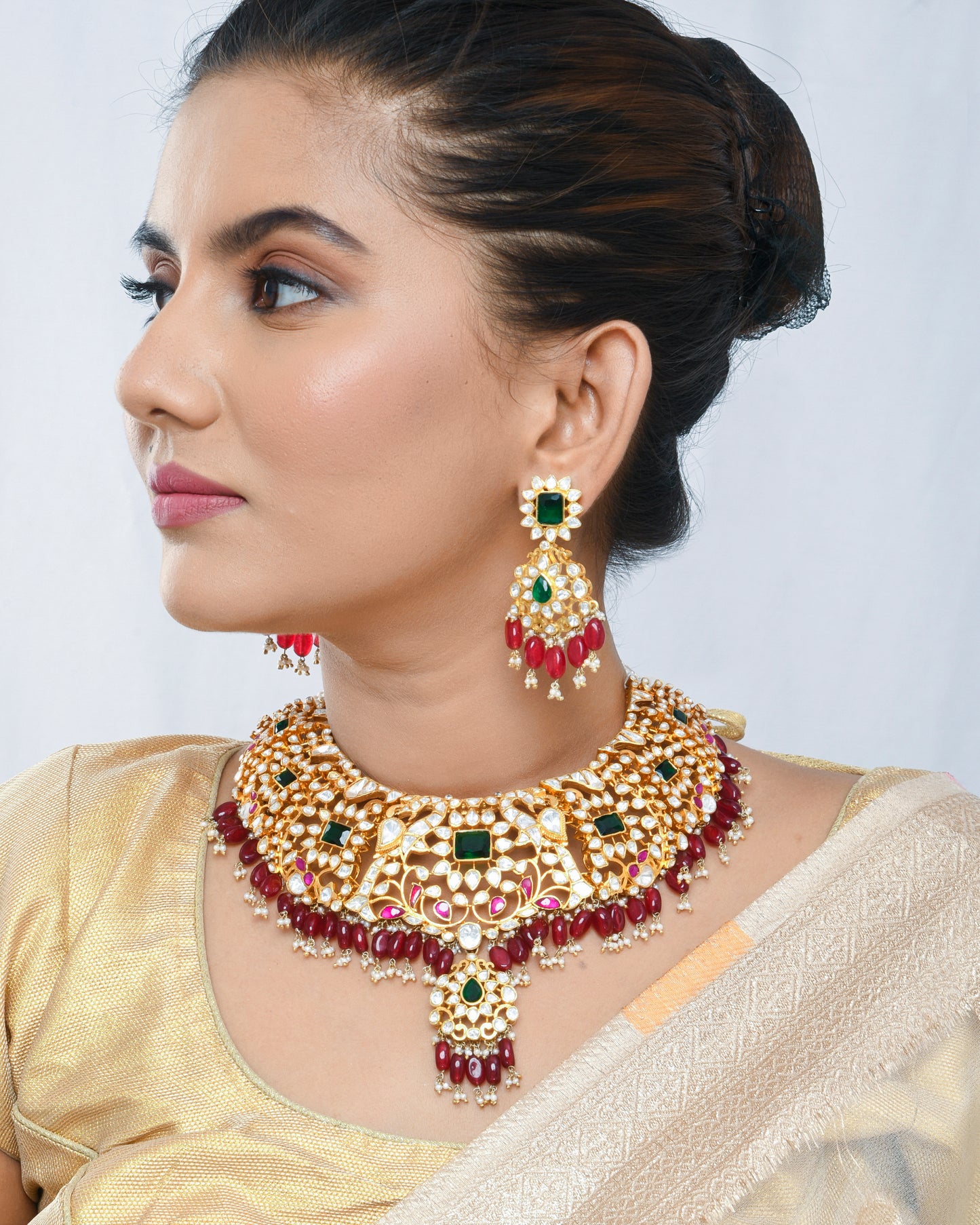 Grand kundan bridal necklace set with emerald and emerald stones and red strawberry beads - Yuvaminie