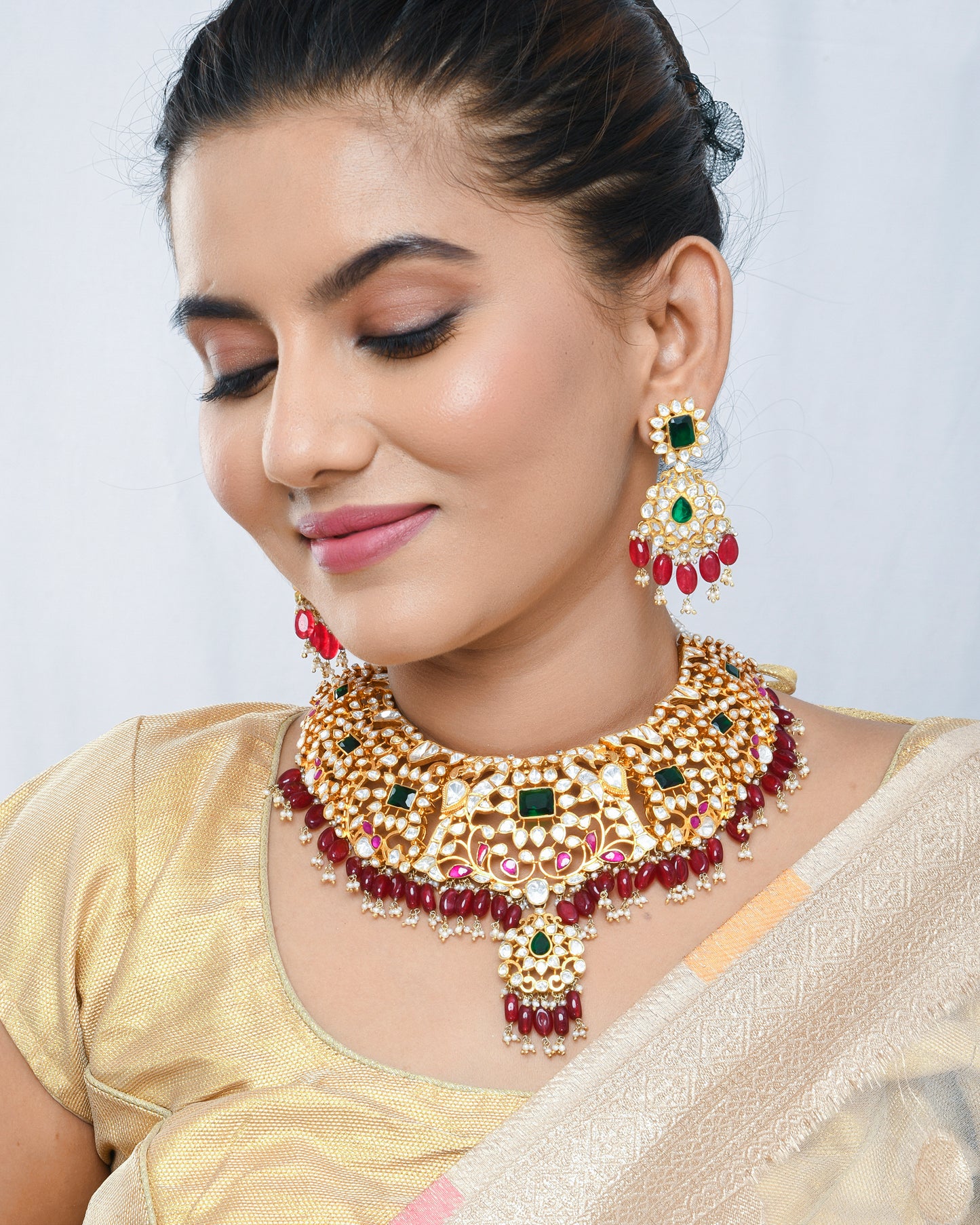 Grand kundan bridal necklace set with emerald and emerald stones and red strawberry beads - Yuvaminie