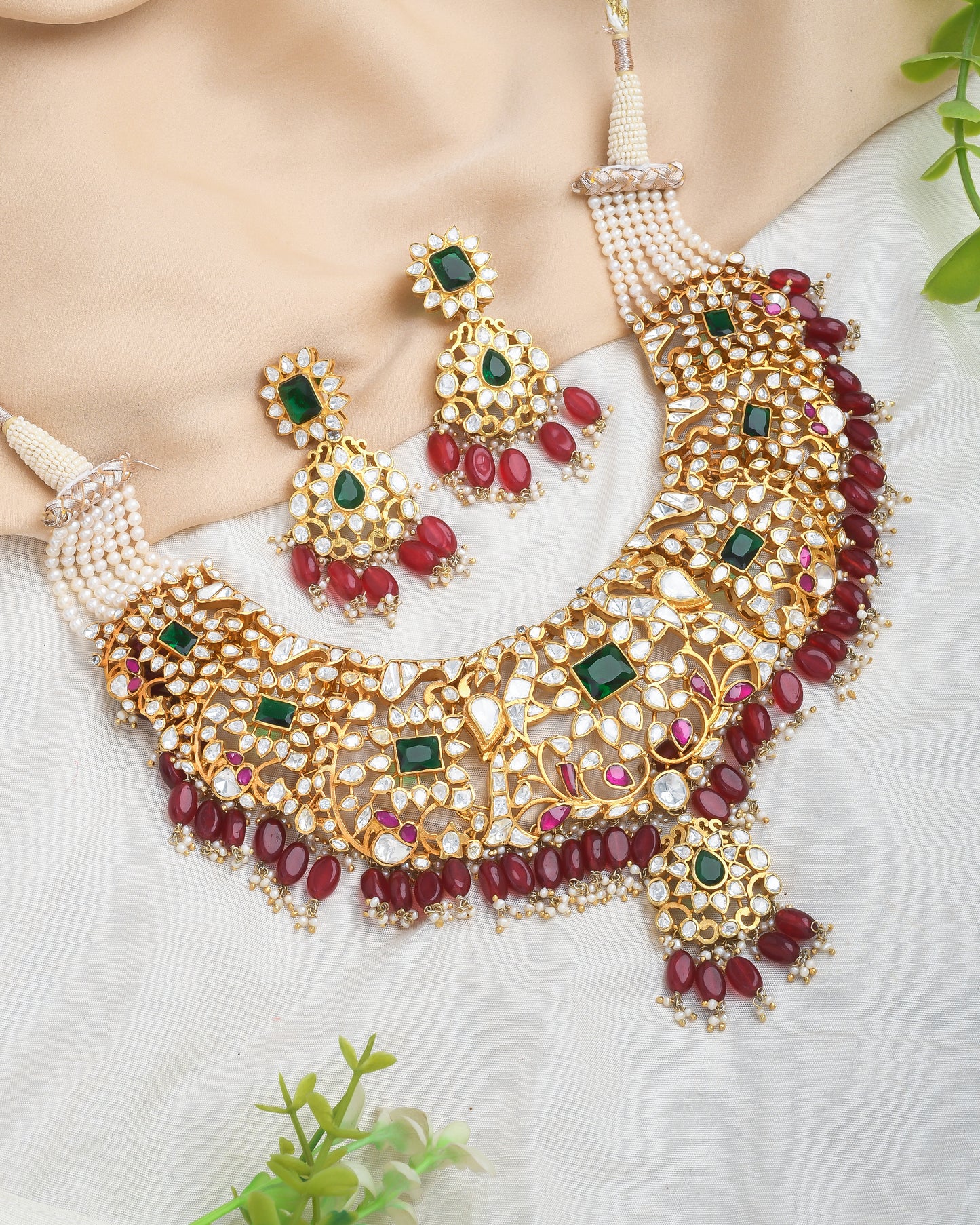 Grand kundan bridal necklace set with emerald and emerald stones and red strawberry beads - Yuvaminie