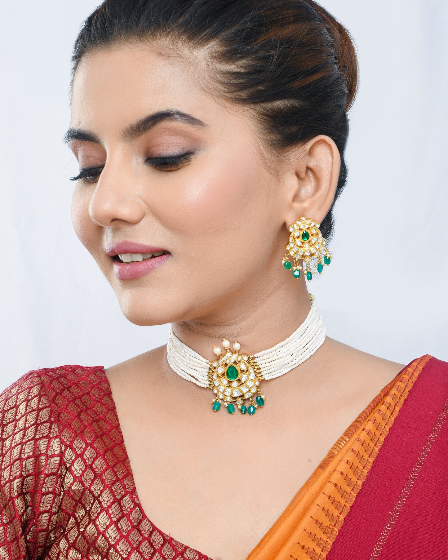 Pearl beaded kundan style necklace set with green stones pendant and earrings - Yuvaminie