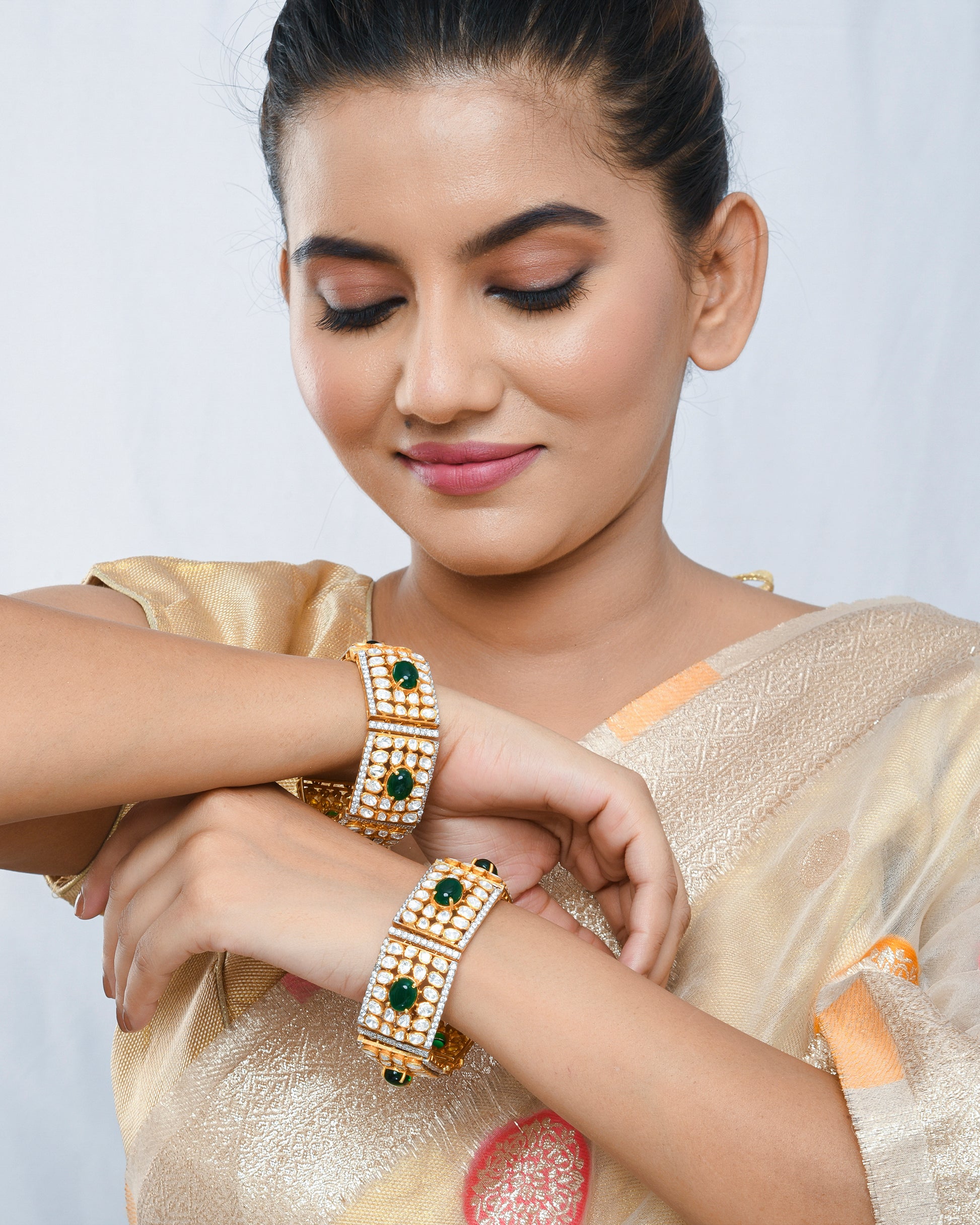 Polki and green stones traditional pair of bracelets - Yuvaminie