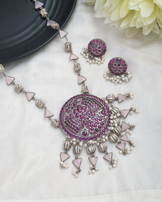 Oxidised silver peacock motif necklace set with magenta accents - Yuvaminie