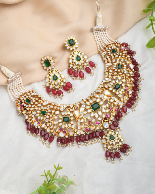Grand kundan bridal necklace set with emerald and emerald stones and red strawberry beads - Yuvaminie